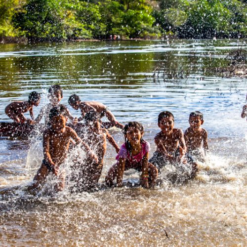 Children splashing in water in the Nii Kaniti project, Peru.